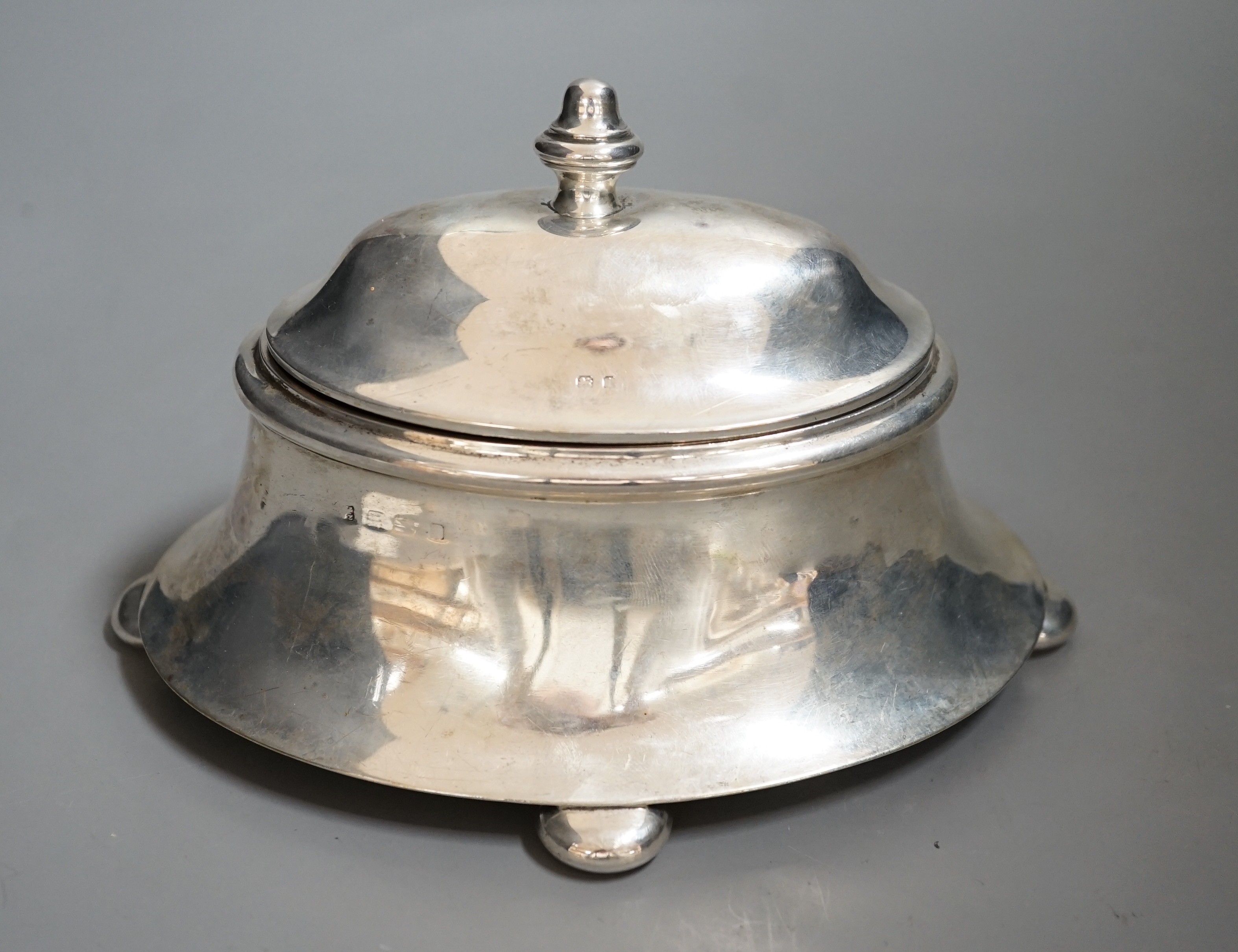 An early 20th century silver oval box, with hinged cover, on bun feet marks rubbed, length 18.5cm